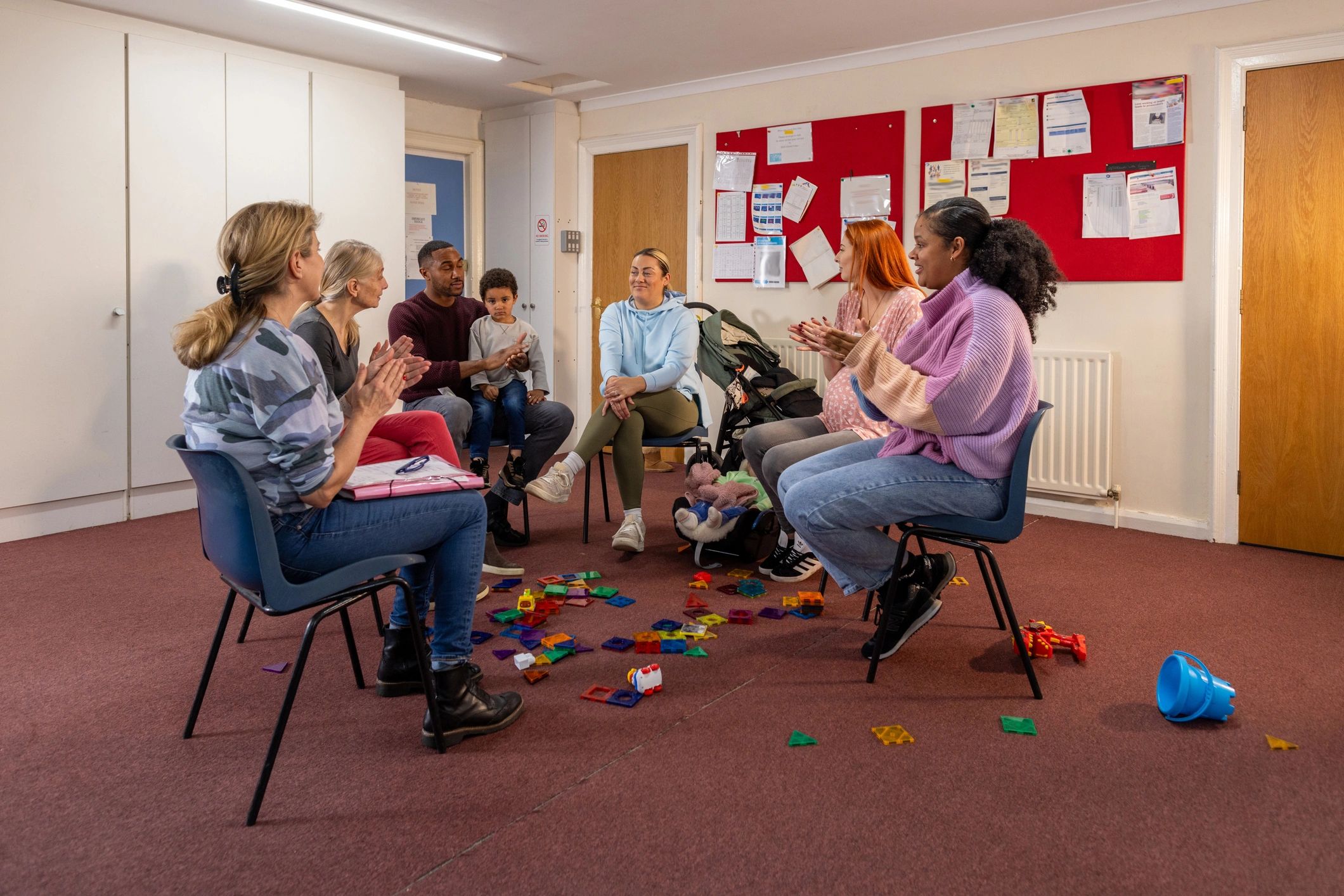 Young adults and families meeting in a community hall
